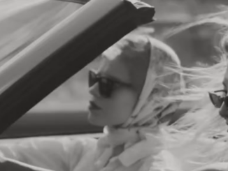 Vintage B&W photograph of 2 women in a car