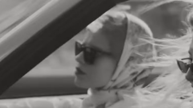 Vintage B&W photograph of 2 women in a car