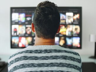 Man watching TV in living room